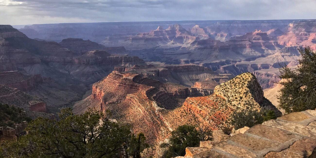 Layered Grand Canyon view from Grandview Point beneath passing clouds