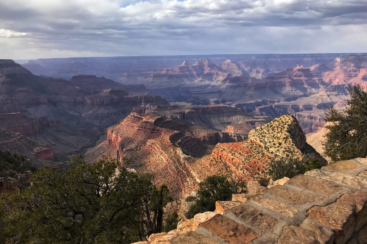 Layered Grand Canyon view from Grandview Point beneath passing clouds