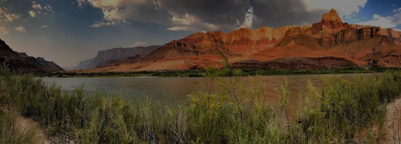 Darkened panoramic view of the Colorado River winding through the Grand Canyon