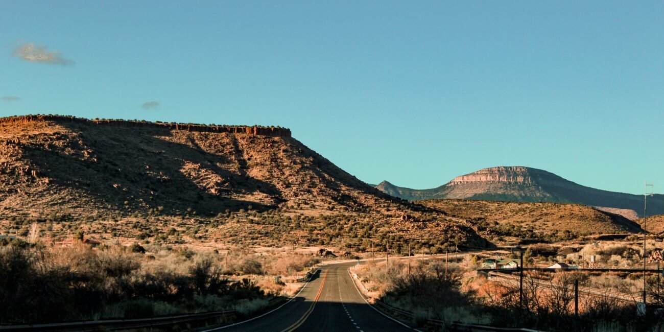 Scenic Arizona road stretching through a red-rock desert landscape