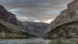 Colorado River flowing through the inner Grand Canyon beneath stormy blue clouds