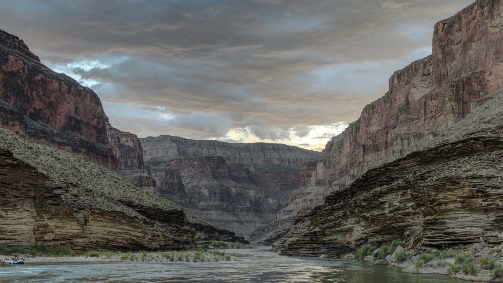 Colorado River flowing through the inner Grand Canyon beneath stormy clouds