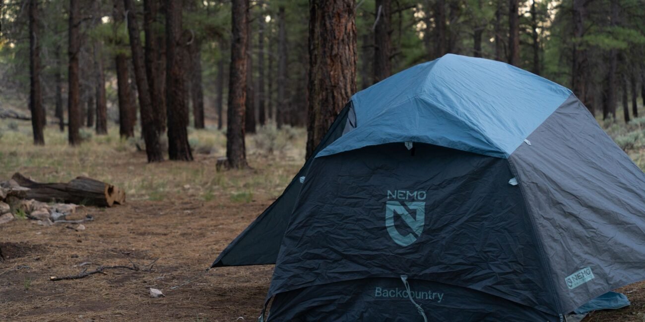Tent set up among pine trees in an Arizona forest near Grand Canyon National Park