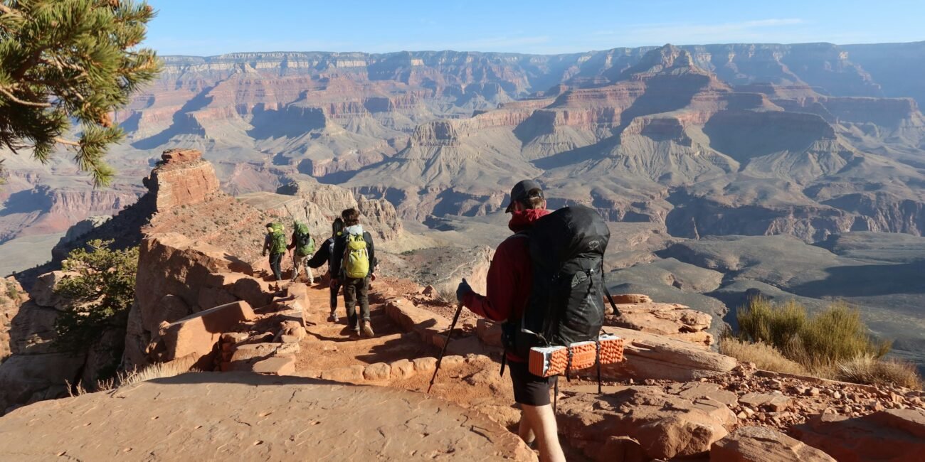 Hikers following a scenic trail above the Grand Canyon