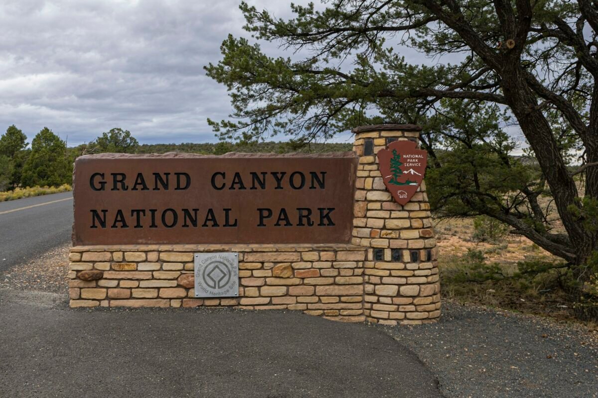 Grand Canyon National Park South Entrance sign beside Arizona Route 64