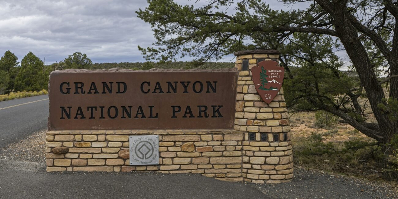 Grand Canyon National Park South Entrance sign beside Arizona Route 64
