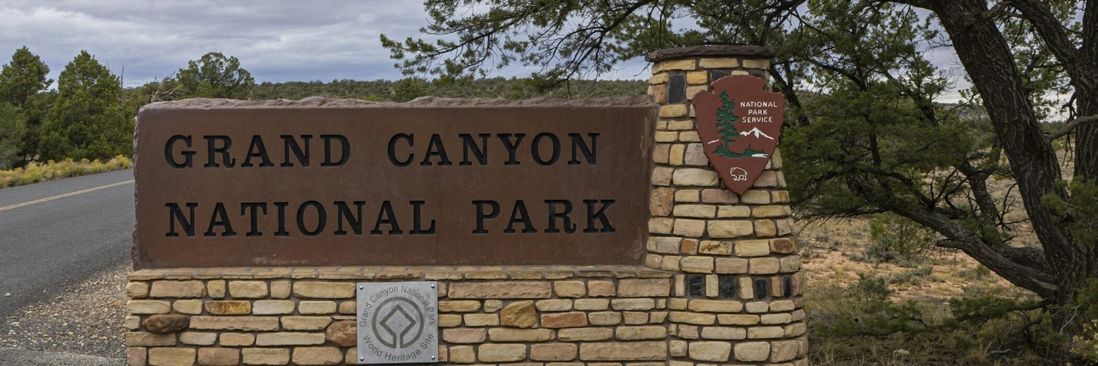 Grand Canyon National Park South Entrance sign beside Arizona Route 64