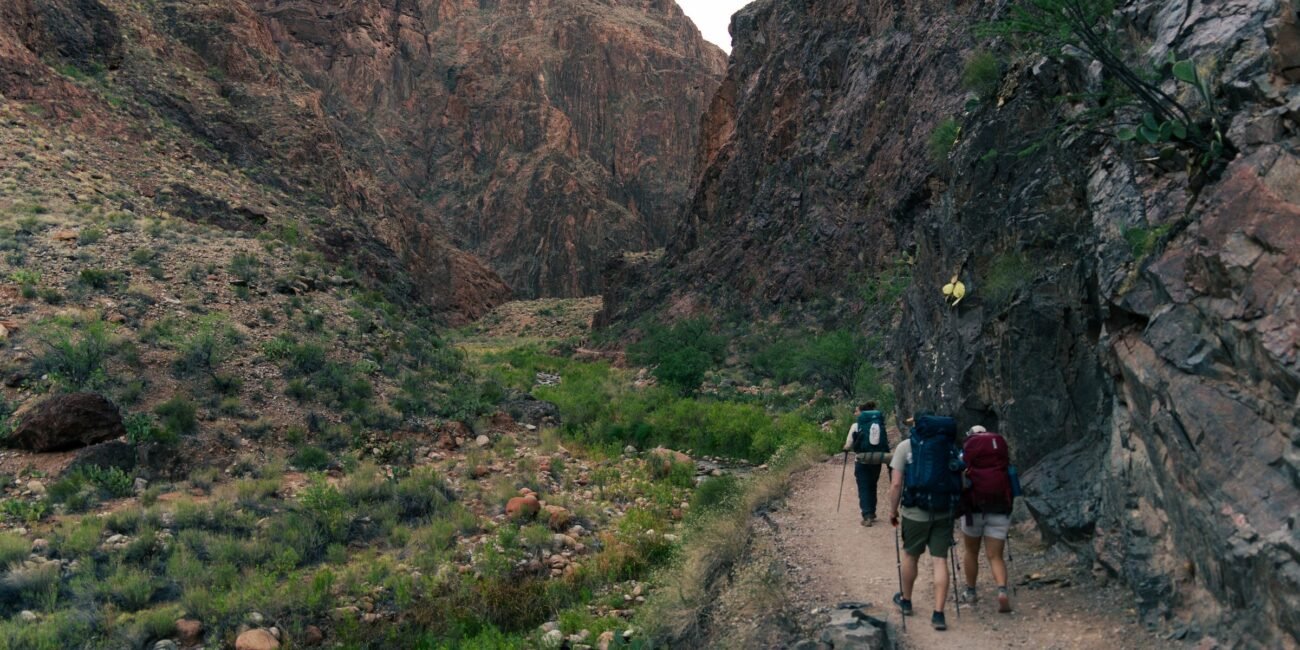 Hikers traveling along a scenic Grand Canyon backcountry trail