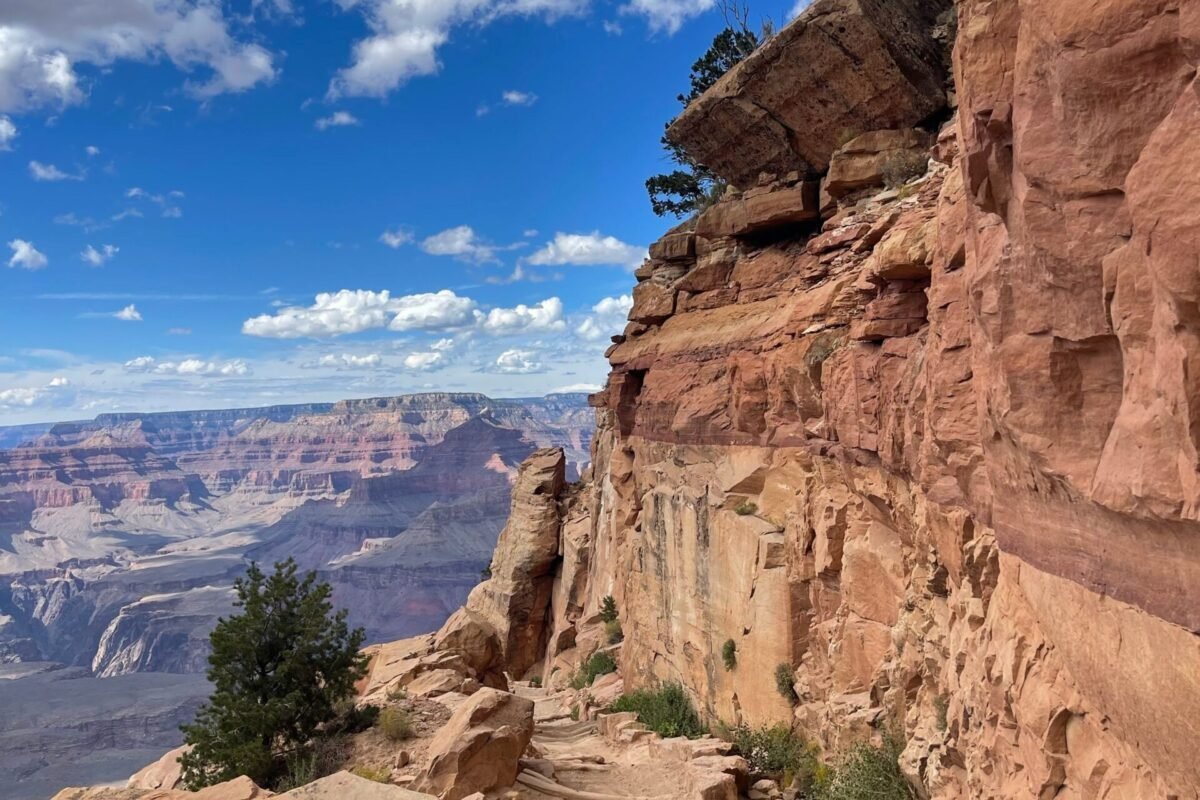 Grand Canyon hiking trail winding along layered canyon cliffs