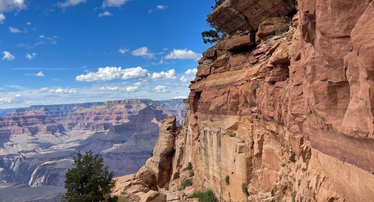 Grand Canyon hiking trail winding along layered canyon cliffs