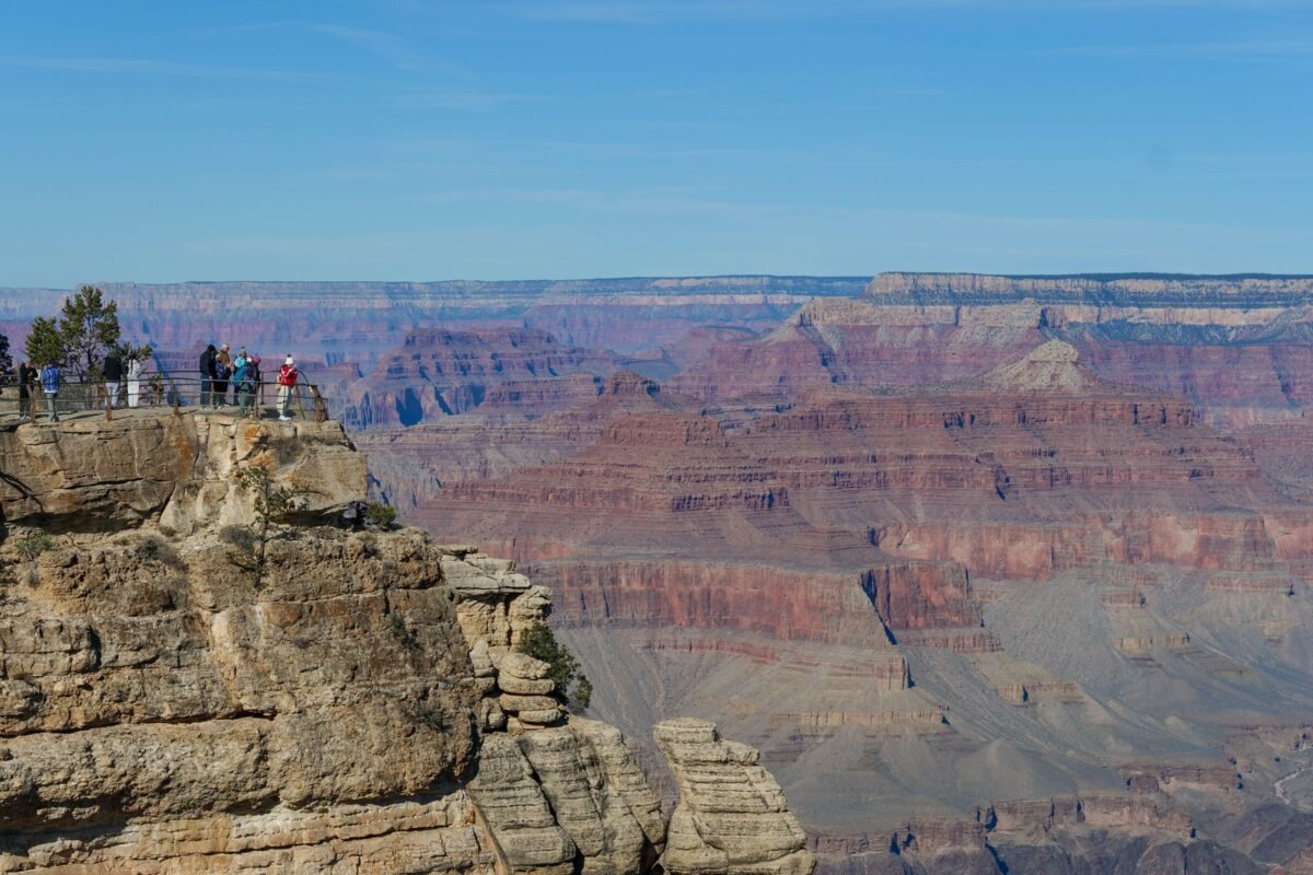 Visitors taking in the broad landscape from the Grand Canyon South Rim