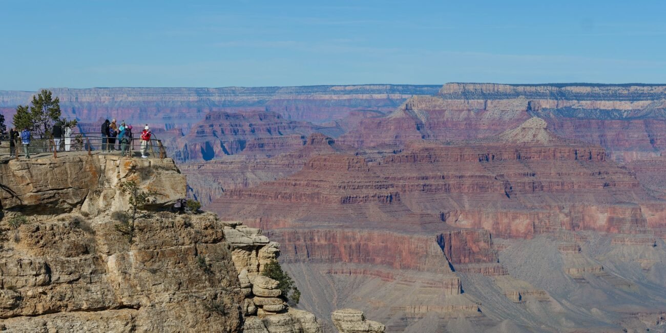 Visitors taking in the broad landscape from the Grand Canyon South Rim