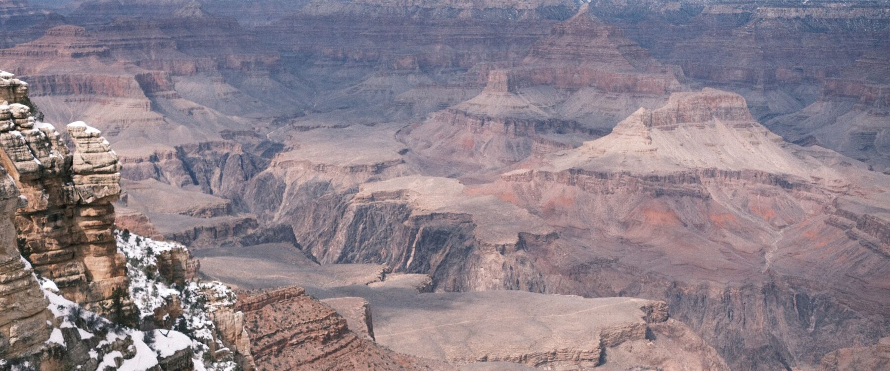 Snow-covered Grand Canyon cliffs and rim landscape in winter