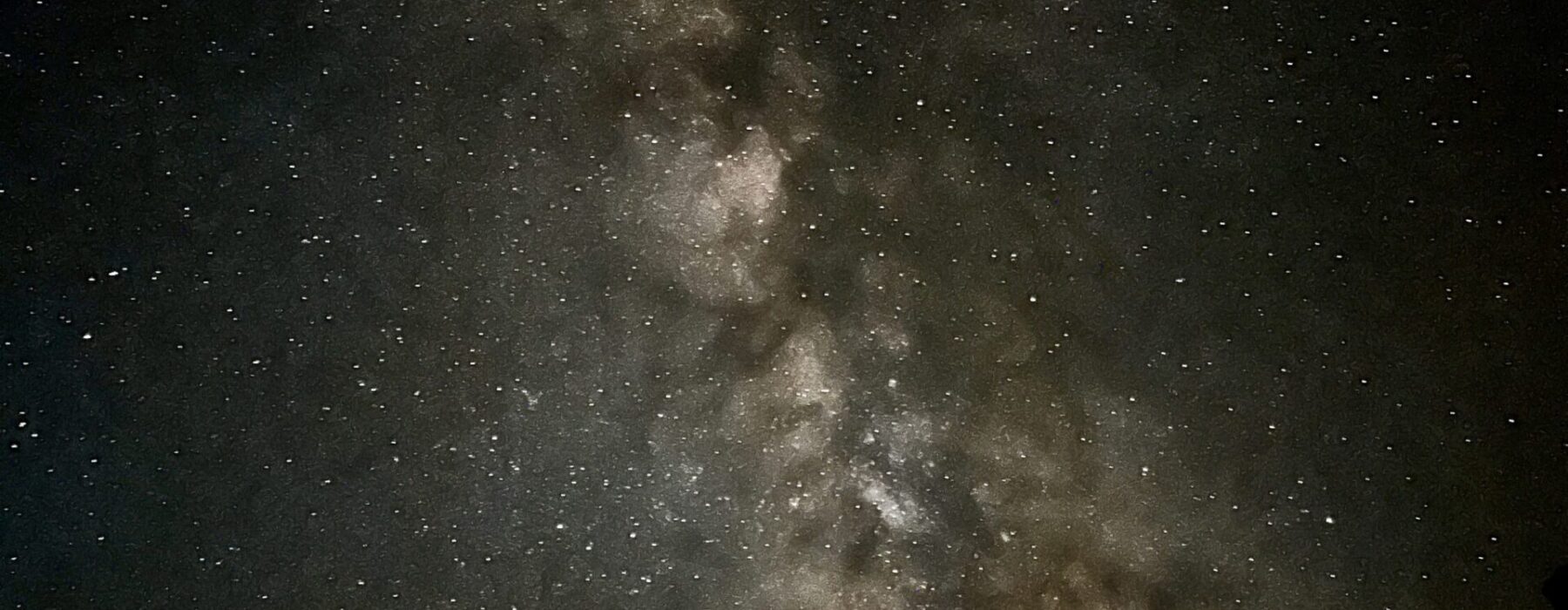 Milky Way visible above dark Grand Canyon silhouettes