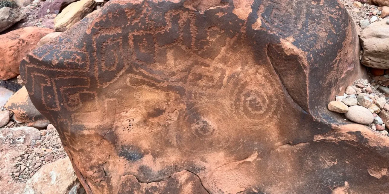 Ancient petroglyphs carved into dark Grand Canyon rock
