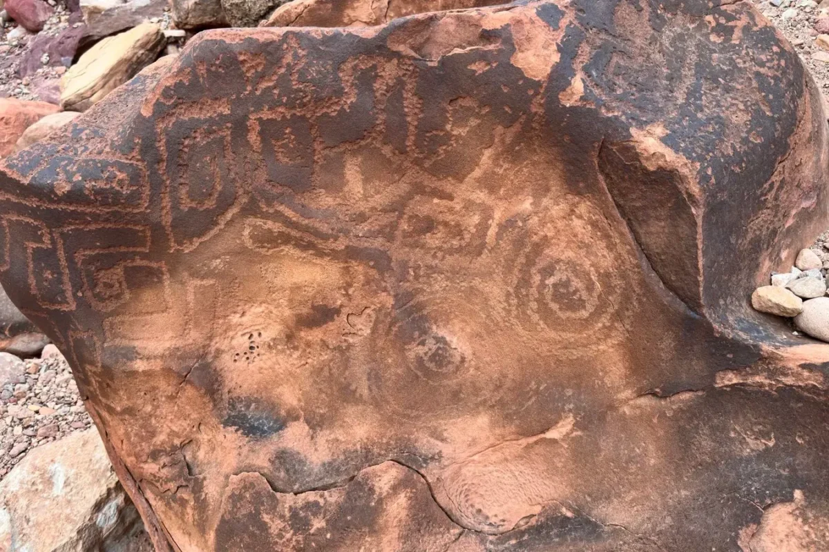 Ancient petroglyphs carved into dark Grand Canyon rock