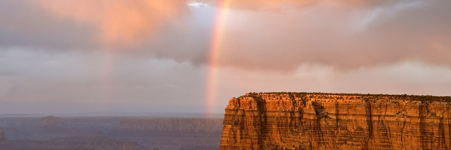 Rainbow descending toward a Grand Canyon butte