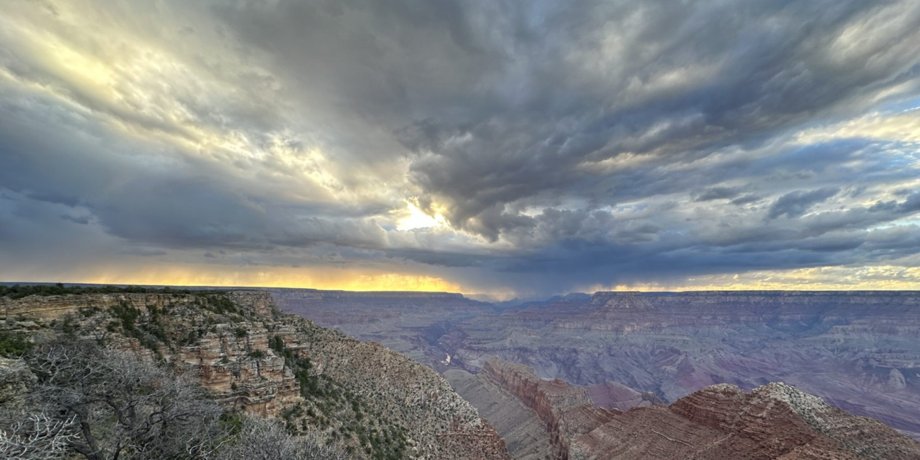 Storm clouds above layered Grand Canyon cliffs