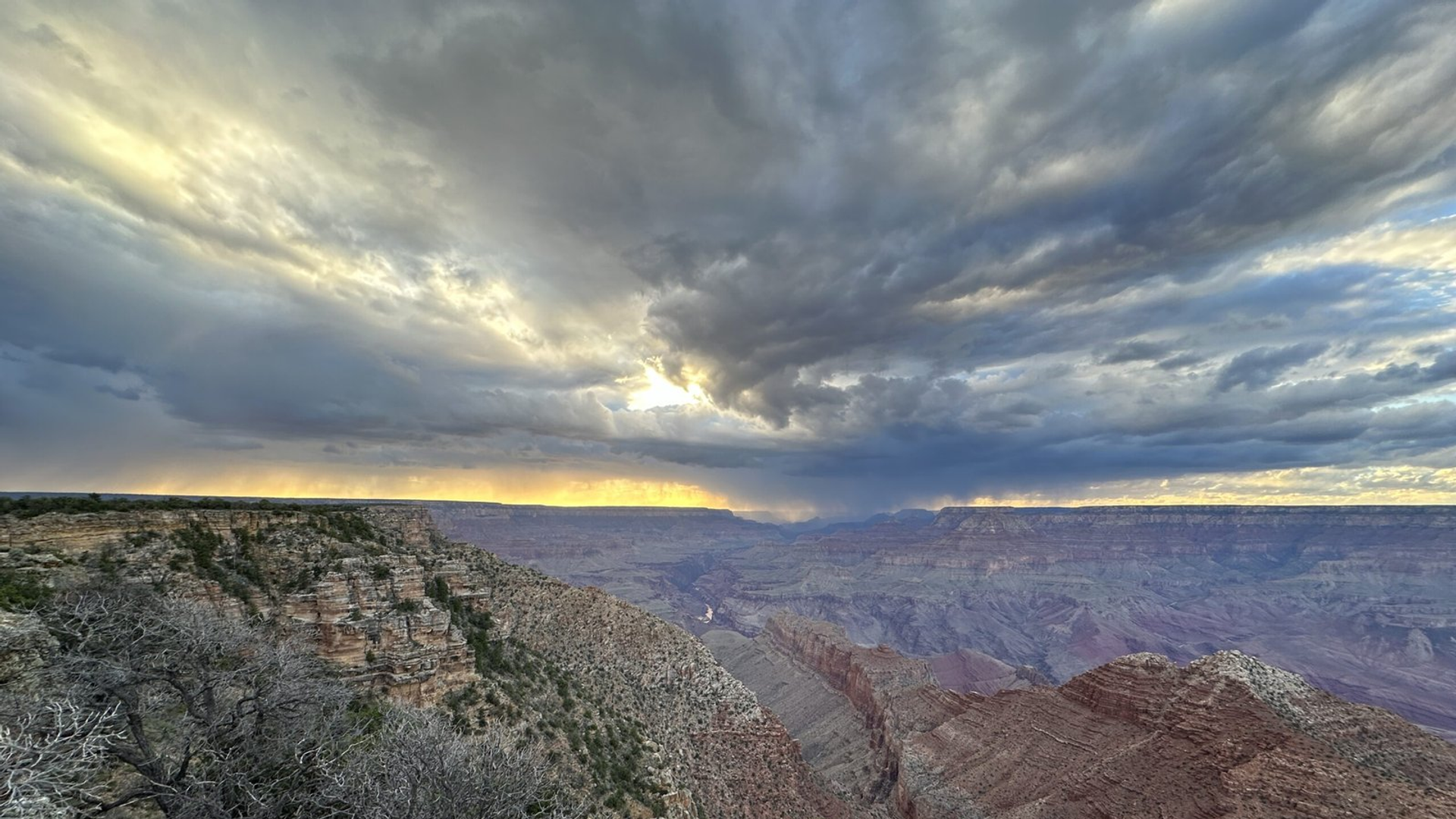 Storm clouds above layered Grand Canyon cliffs