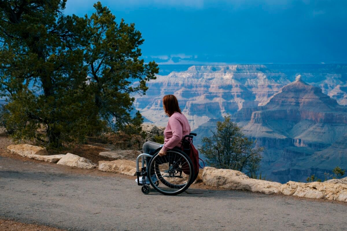Wheelchair user looking out over the Grand Canyon from a rim overlook