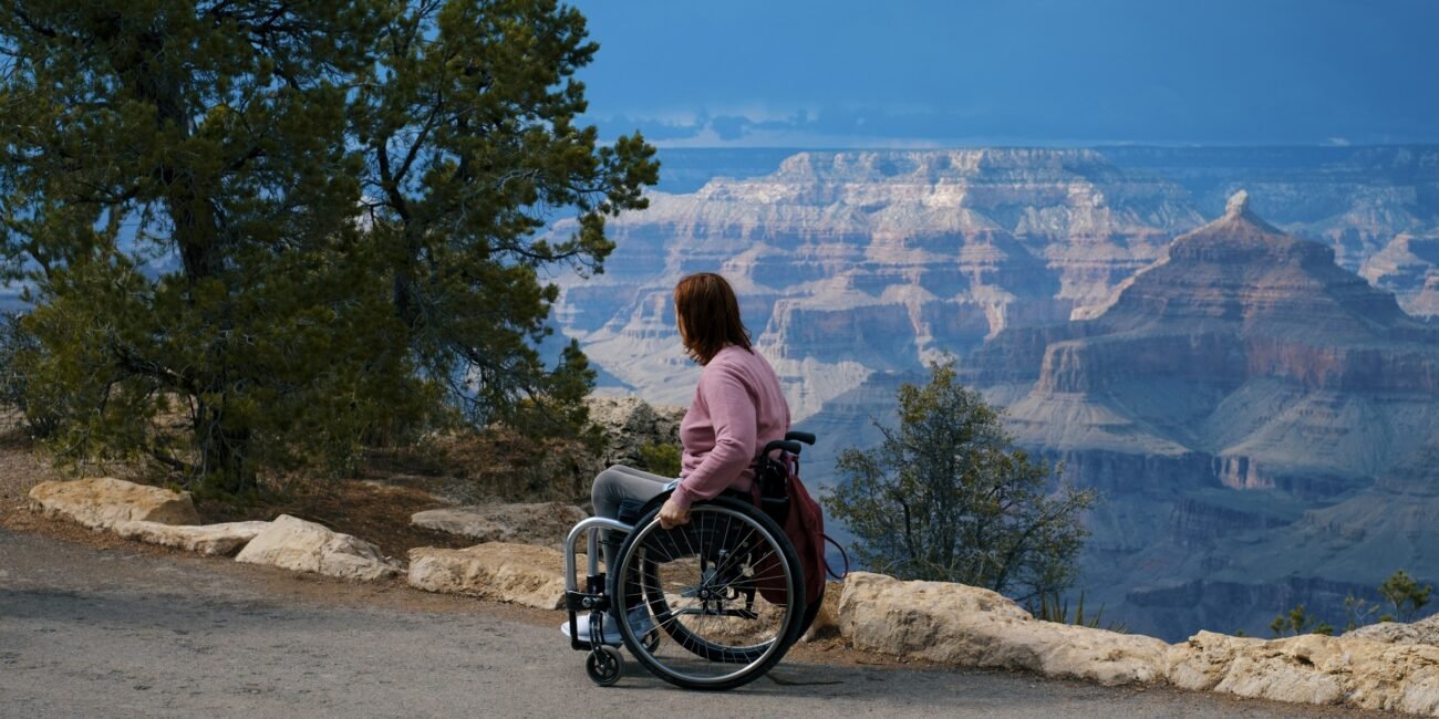 Wheelchair user looking out over the Grand Canyon from a rim overlook
